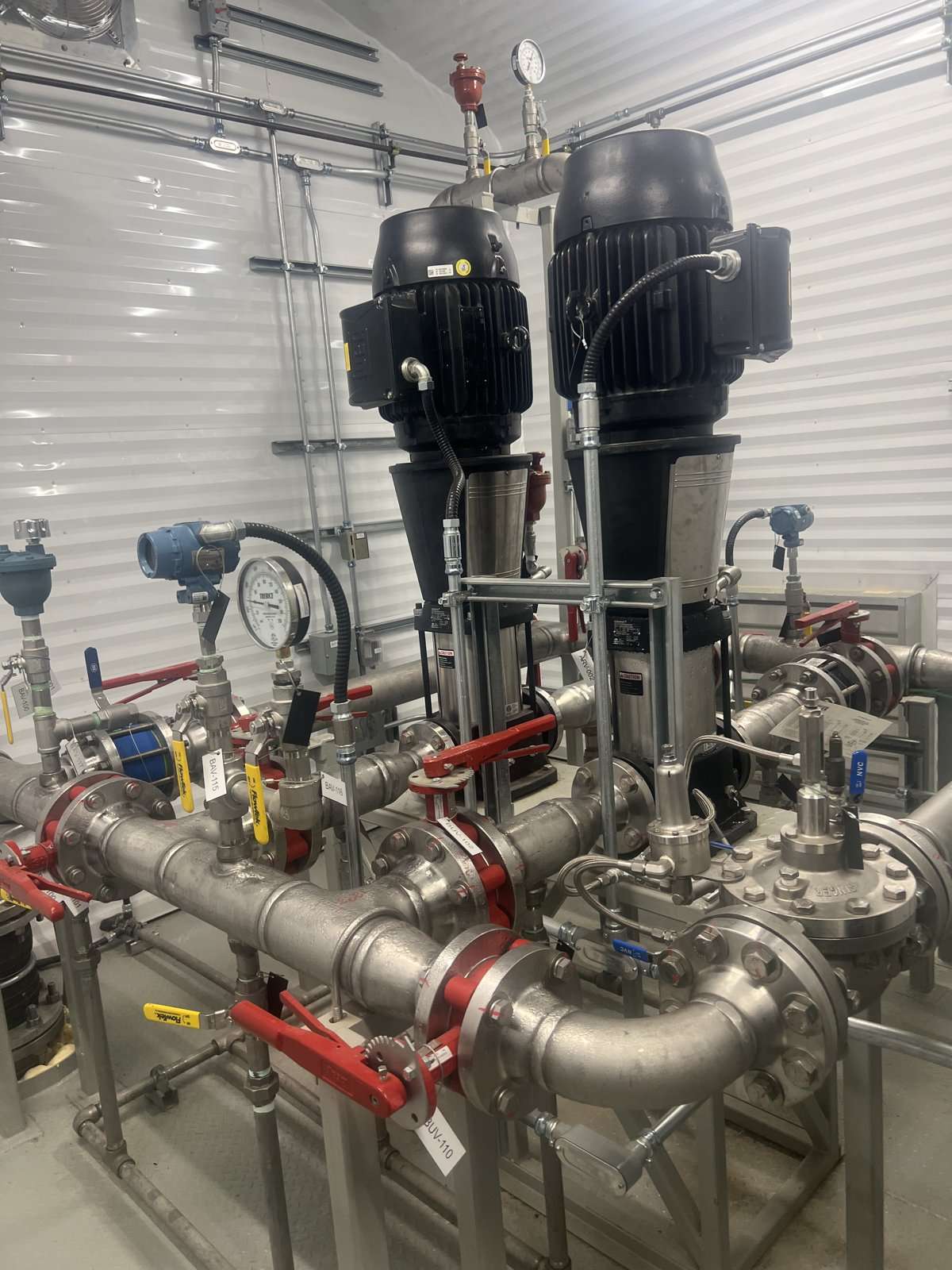 Pumps and stainless piping in an existing Lacombe County pump room